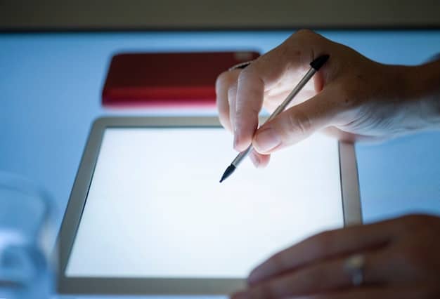 A close-up shot of a person filling out the FAFSA form on a laptop, with a pen in hand. The focus is on the form and the act of applying, highlighting the new streamlined process.