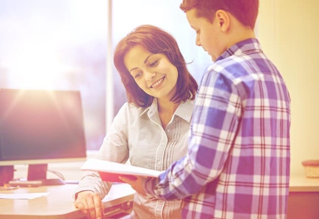 A friendly financial aid advisor assisting a student at a university office. The setting is professional and supportive, focused on helping the student understand their financial aid options. The advisor is pointing to a document, likely explaining grant details.