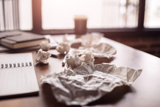 A cluttered desk with discarded papers; in focus, a student who looks stressed and worried.