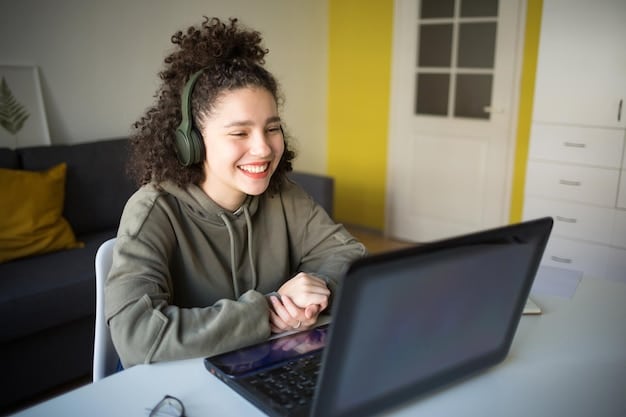 A young student using a screen reader on a laptop in a quiet library setting. The student is smiling, indicating a positive and empowering experience with assistive technology.
