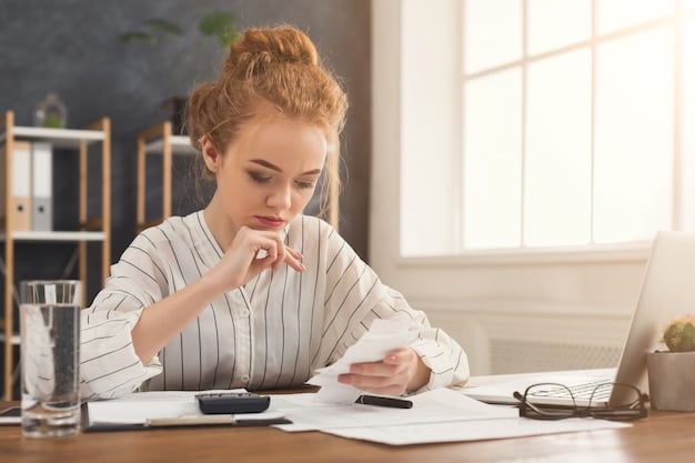 A person sitting at a desk reviewing tax documents with a calculator and pen in hand, focused on understanding the income limits for the Child Tax Credit.