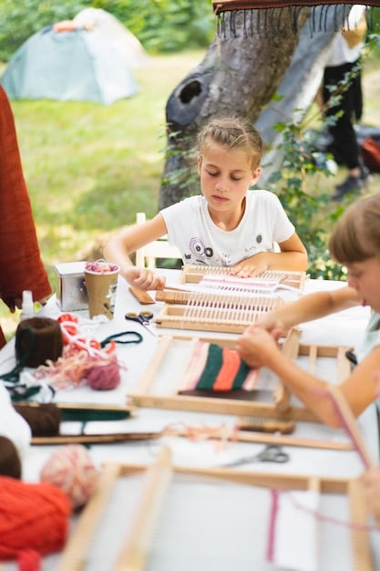 Children participating in various summer camp activities, such as arts and crafts, sports, and outdoor adventures.