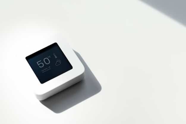 A close-up of a smart thermostat installed on a wall, displaying energy-saving settings and indicating reduced energy consumption.