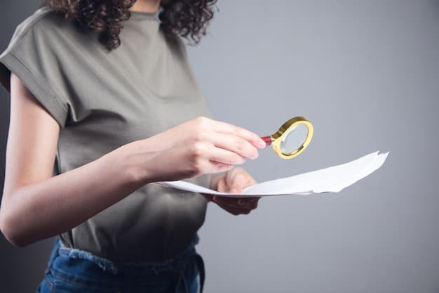 A person holding a magnifying glass over a document labeled 