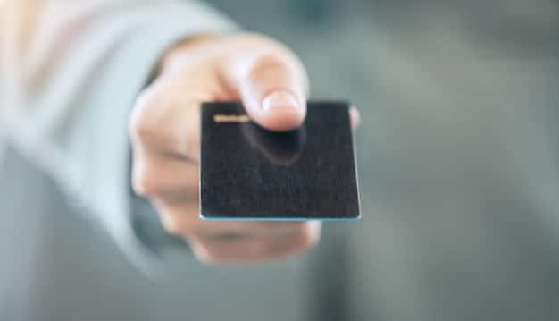 A close-up of a hand holding a Social Security card. The card should appear slightly worn, symbolizing the long-term reliance on these benefits.