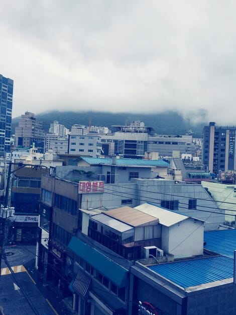 A split image showing two factories. On the left, a Chinese factory with rows of workers, and on the right, an American factory with advanced automation and few workers, representing the shift in manufacturing due to trade war.