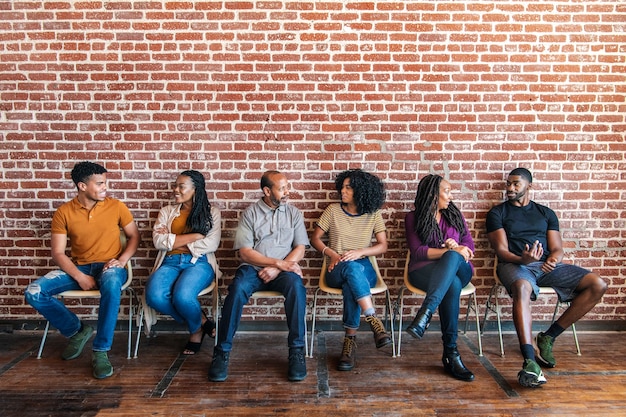 A diverse group of students sitting in a college lecture hall, attentively listening to the professor. The atmosphere is engaging and supportive, symbolizing equal access to education. Text overlay: 