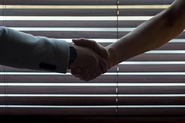 A close-up shot of two hands shaking firmly, symbolizing agreement and partnership. The background is blurred, suggesting a busy and dynamic corporate environment. This reflects the value of interpersonal skills and networking in the modern workplace when applying the concepts of 5 Unexpected Skills Employers Now Value More Than a College Degree.