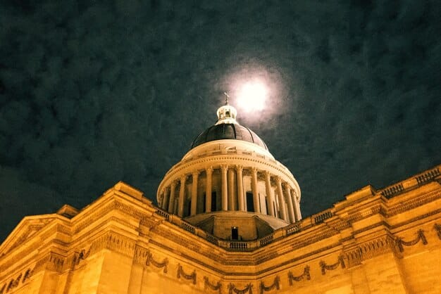 A close-up of the US Capitol building bathed in golden light, representing the legislative power to change tax laws. The image is slightly abstract to focus on the concept of legal change.